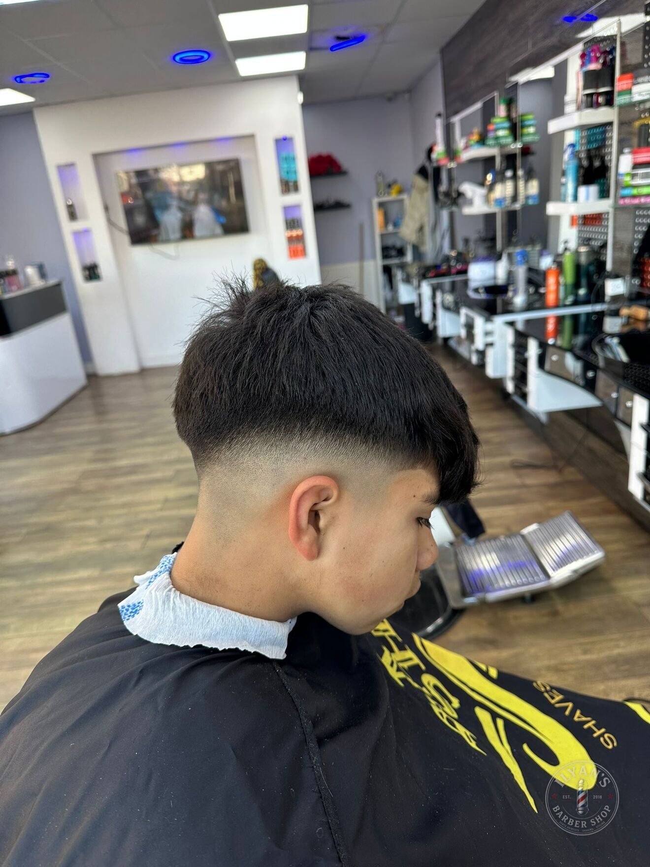 A skin fade cut at Ilyan's Barber Shop, blended down to the skin