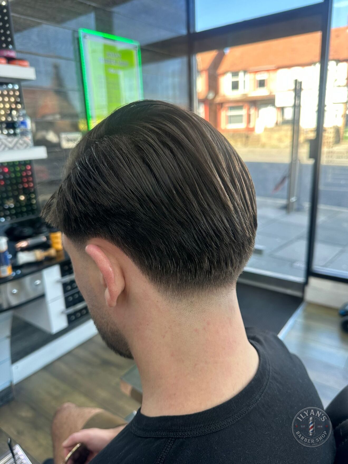 A slick back with a taper at Ilyan's Barber Shop