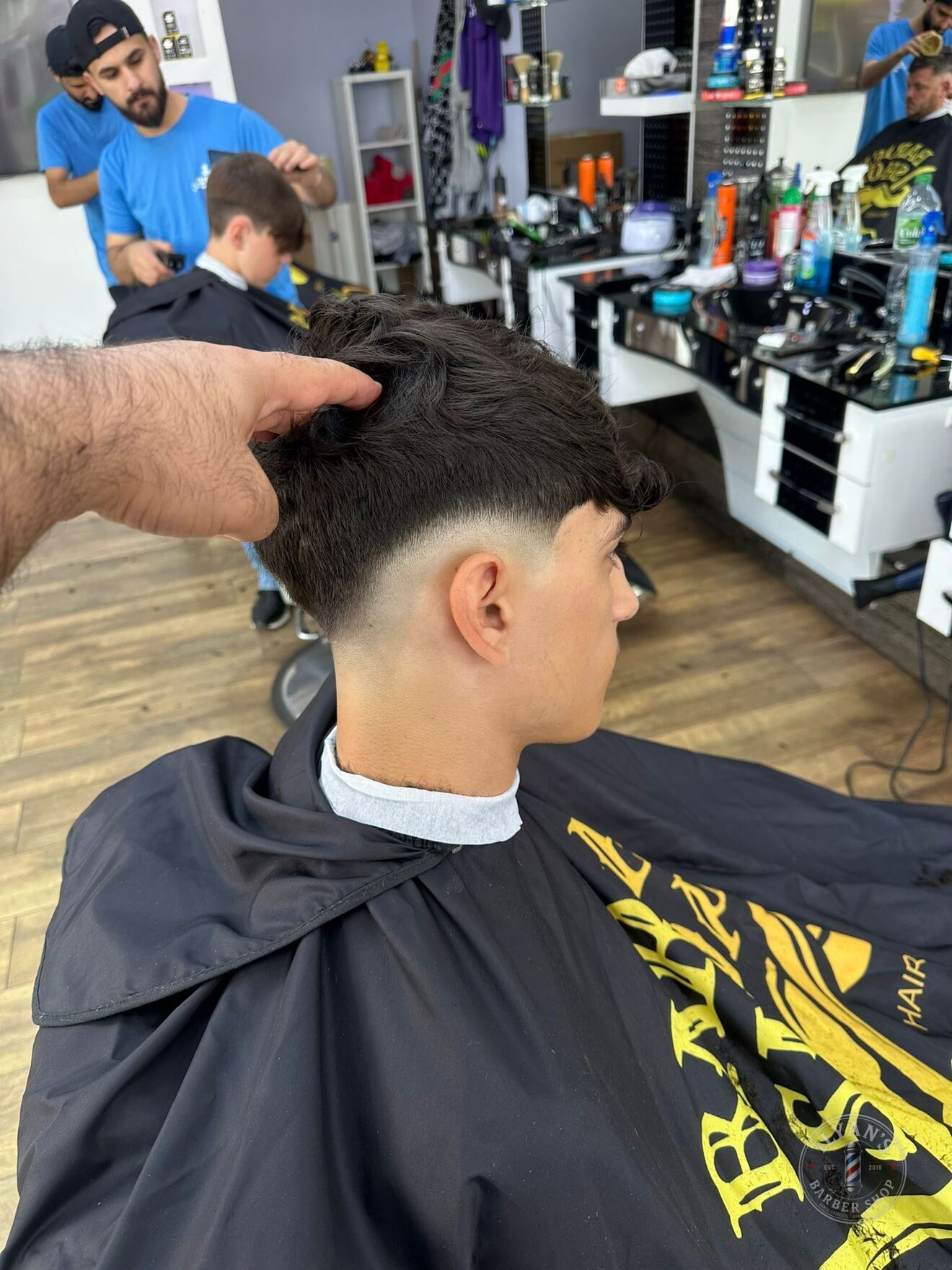 A textured crop with a mid skin fade at Ilyan's Barber Shop
